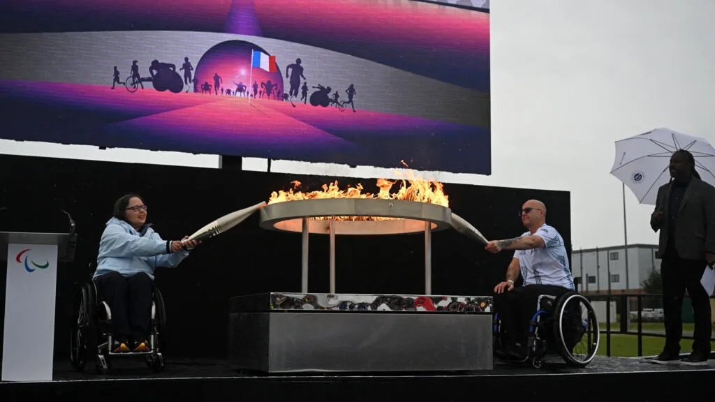 Paris Paralympics flame is lit before journey from English village, under sea and over land