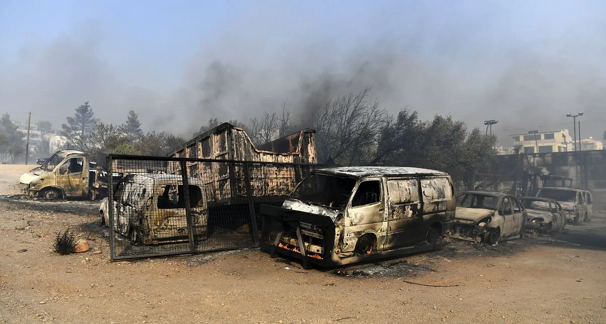 One dead and homes burnt to ground as fires die down in Greece