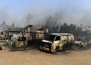 One dead and homes burnt to ground as fires die down in Greece