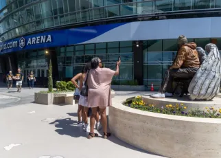 Kobe Bryant and Gianna are sitting near Crypto.com Arena entrance named after Lakers icon