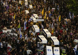 Protesters march in Tel Aviv with makeshift coffins to demand release of Gaza hostages