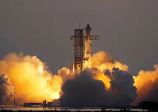 SpaceX catches Starship rocket booster as it returns to Earth